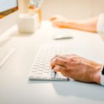 a man working on a white computer