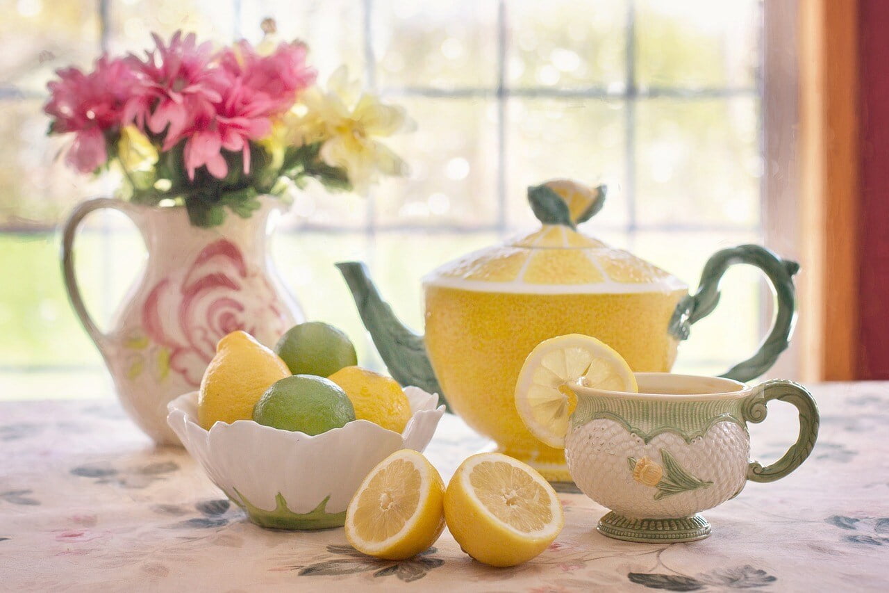 a table with tea cups and teapots