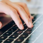 a close-up of a hand on a laptop keyboard