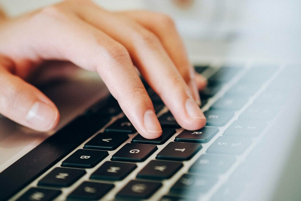 a close-up of a hand on a laptop keyboard