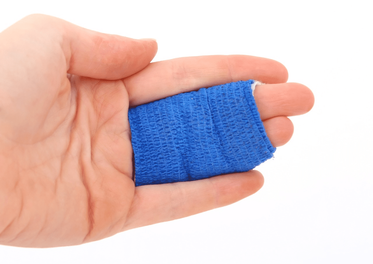 a hand holding a blue and white square object