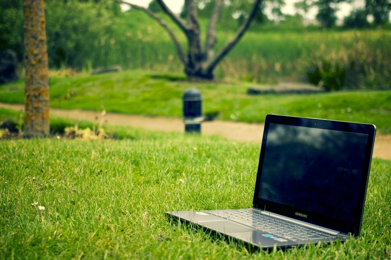 a laptop on a lawn
