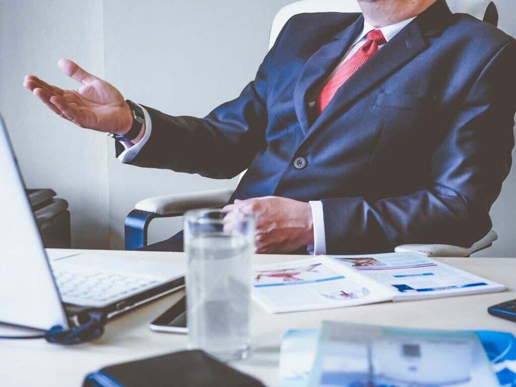 a person sitting at a table with the hands on the hips