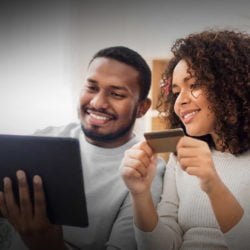 a man and woman looking at a tablet
