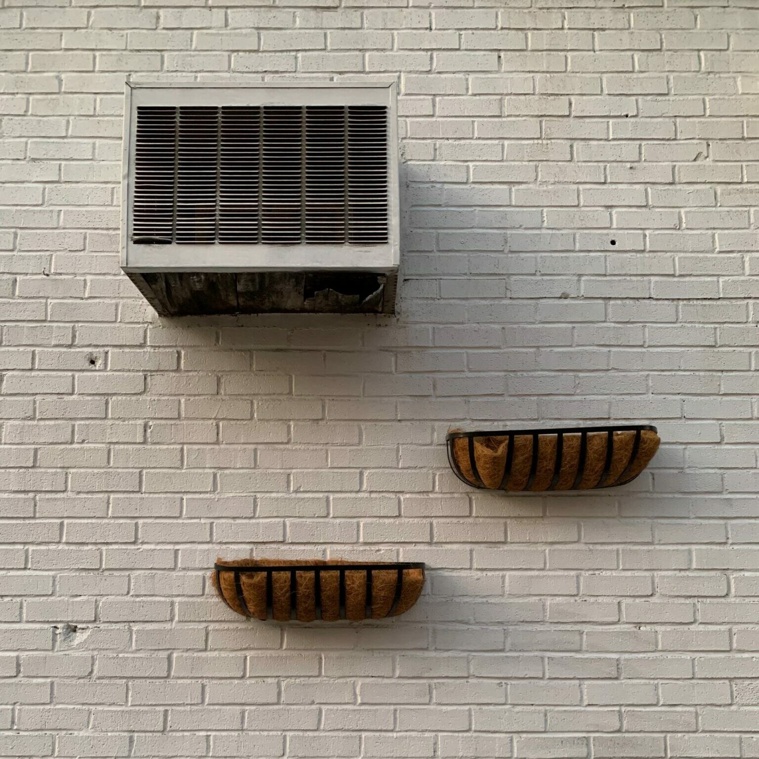 a couple of wooden boxes on a white wall