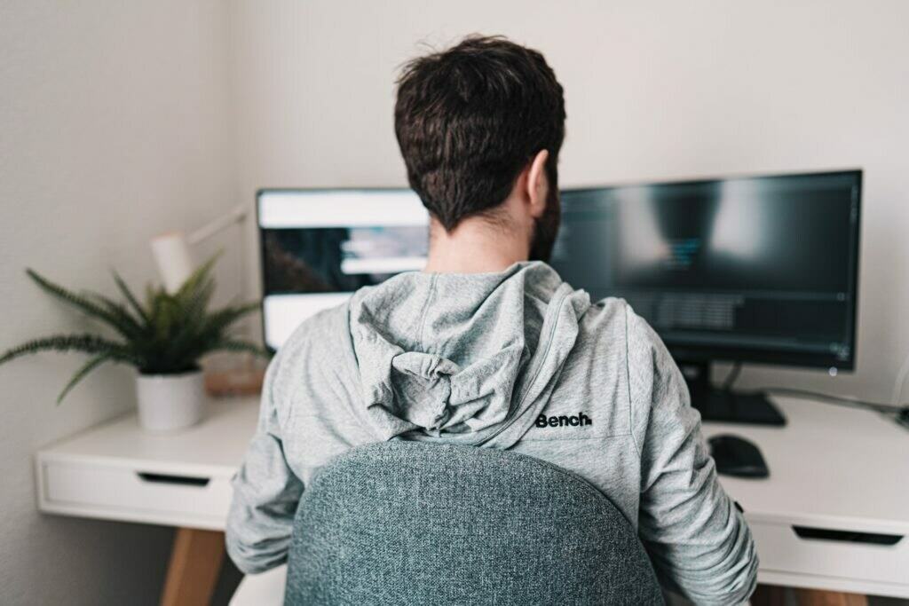 a man sitting in front of a computer