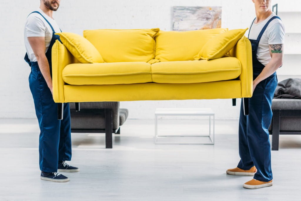 a person standing next to a couch