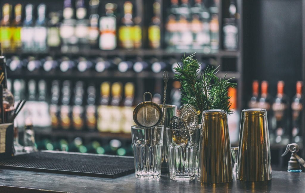 a group of glasses with a plant in them