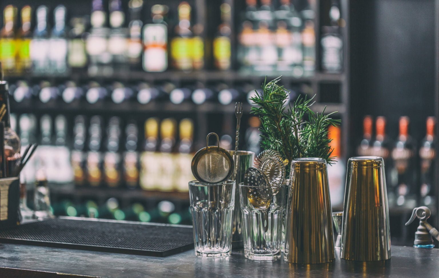 a group of glasses with a plant in them