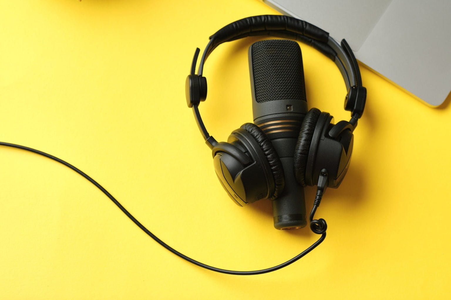 a black headphones on a yellow surface