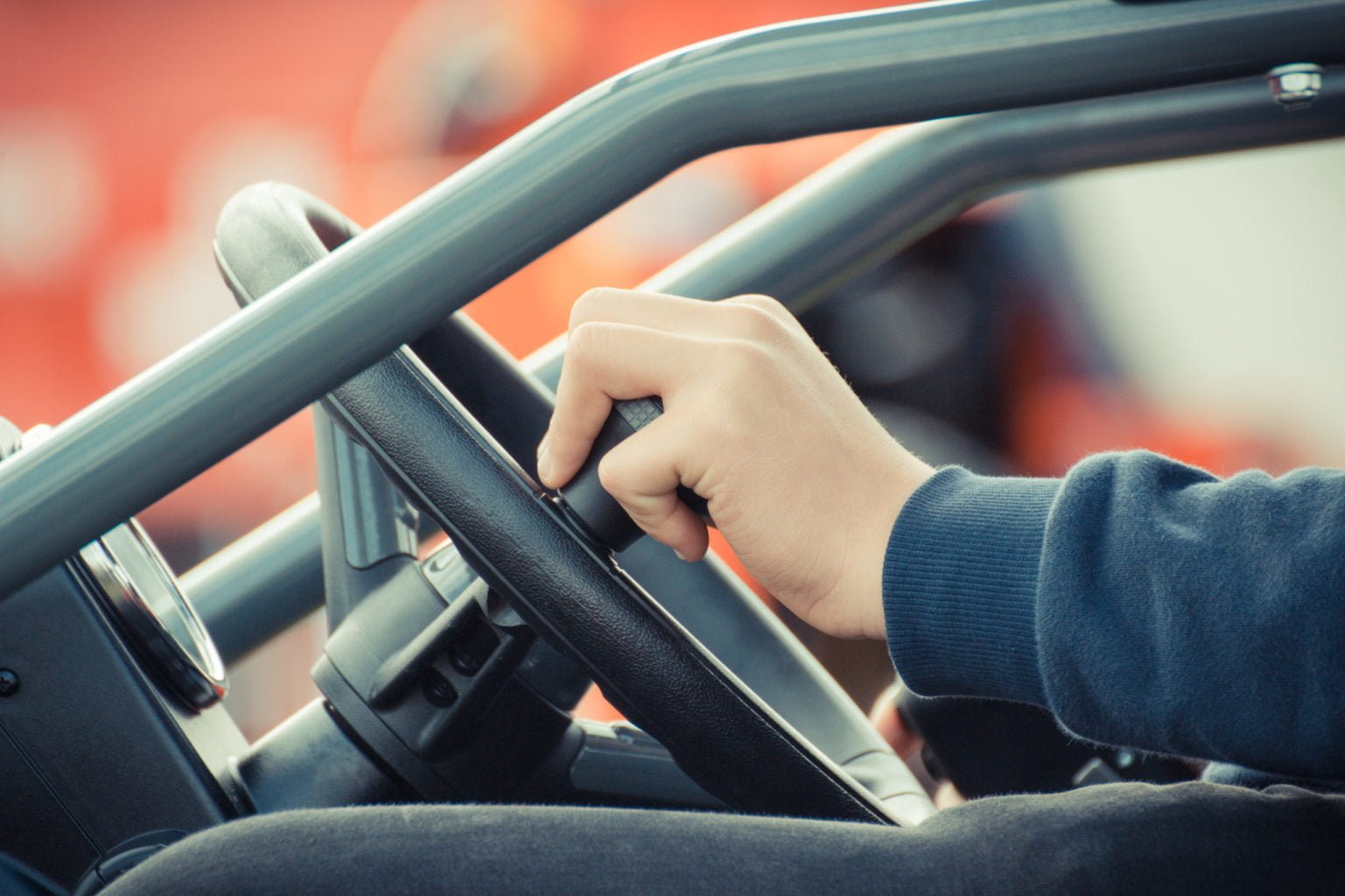 a person's hand holding a phone in a car