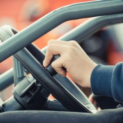 a person's hand holding a phone in a car