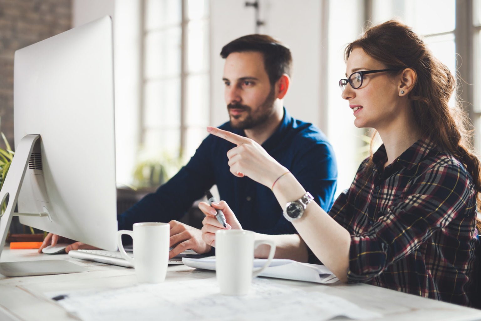 two people looking at a monitor