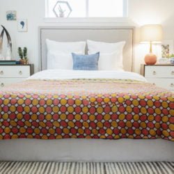 A bed with a retro quilt