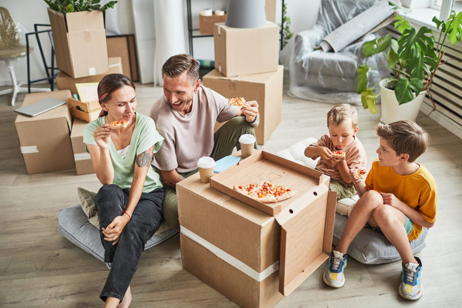 Family Eating Pizza in New Home
